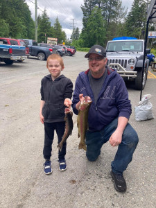 Son Alden has a big grin as he and Dad, Rich, hold upcoming nice sized trout.