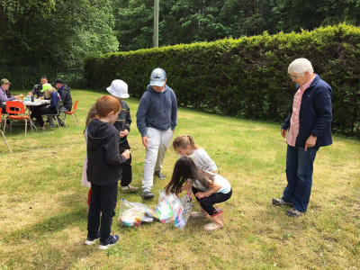 Last year's Derby organizer Denise looks on as kids check over some donated prizes. Walter Hall Community Fishing Derby